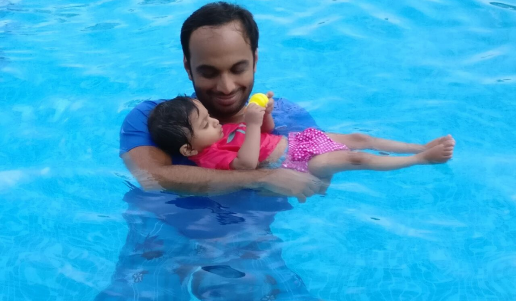 "Faster, Higher And Stronger" - Says Hakimuddin Habibulla. A father carrying his little daughter in a swimming pool.