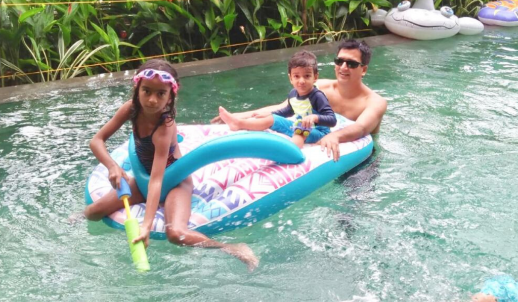 Celebrating Father's Day With Superdad Dr. Shravan Subramanyam. Father in a swimming pool with his two children.