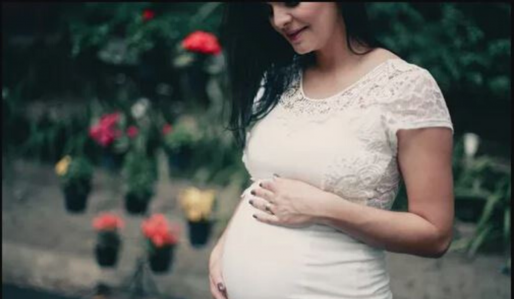 Diet Tips For Pregnant Women. Women in white dress is happy and enjoying motherhood.