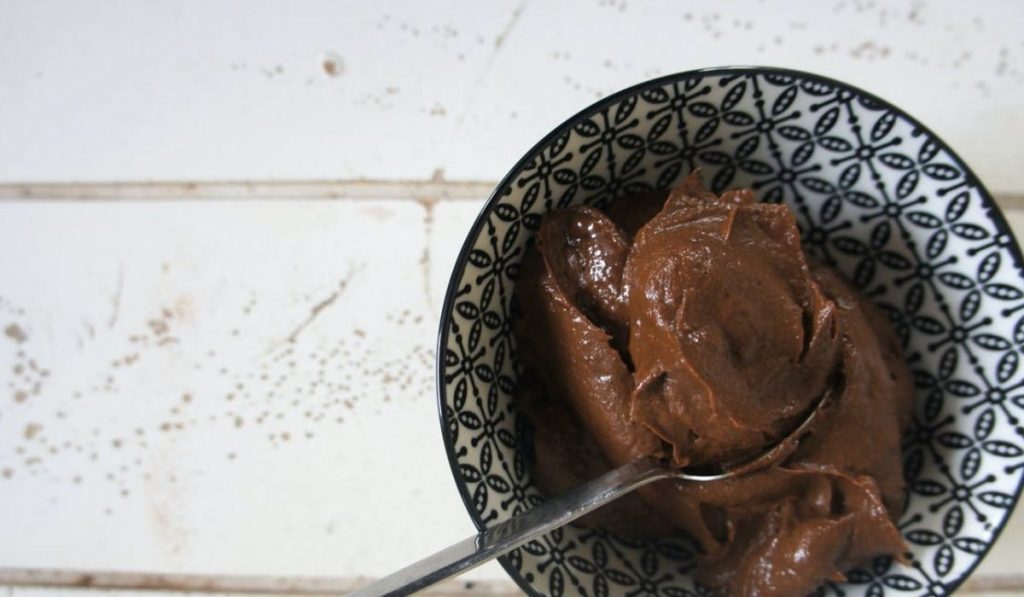 Yummy Finger Millet Rawa Chocolate Pudding. Chocolate pudding kept in a cup with a spoon.