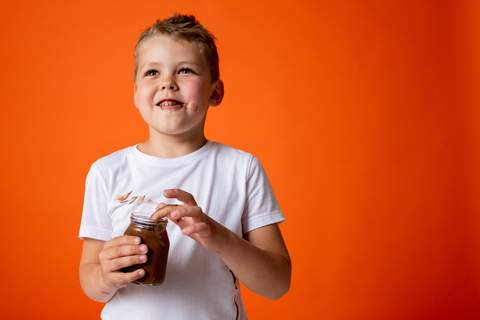 Boy eating chocolate pudding