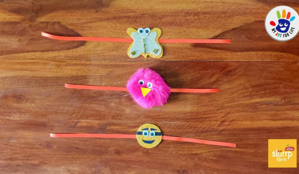 How To Make Rakhi At Home. Three homemade rakhi kept on a wooden table.