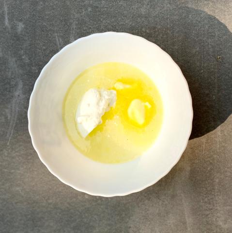A bowl of water, yogurt and butter