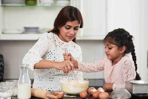 Positive Parenting tips - A girl helping her mother in the kitchen