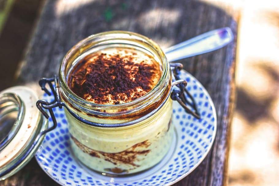Snack Recipe For Kids - Chia Seeds Tiramisu kept in a glass jar with a spoon on the side