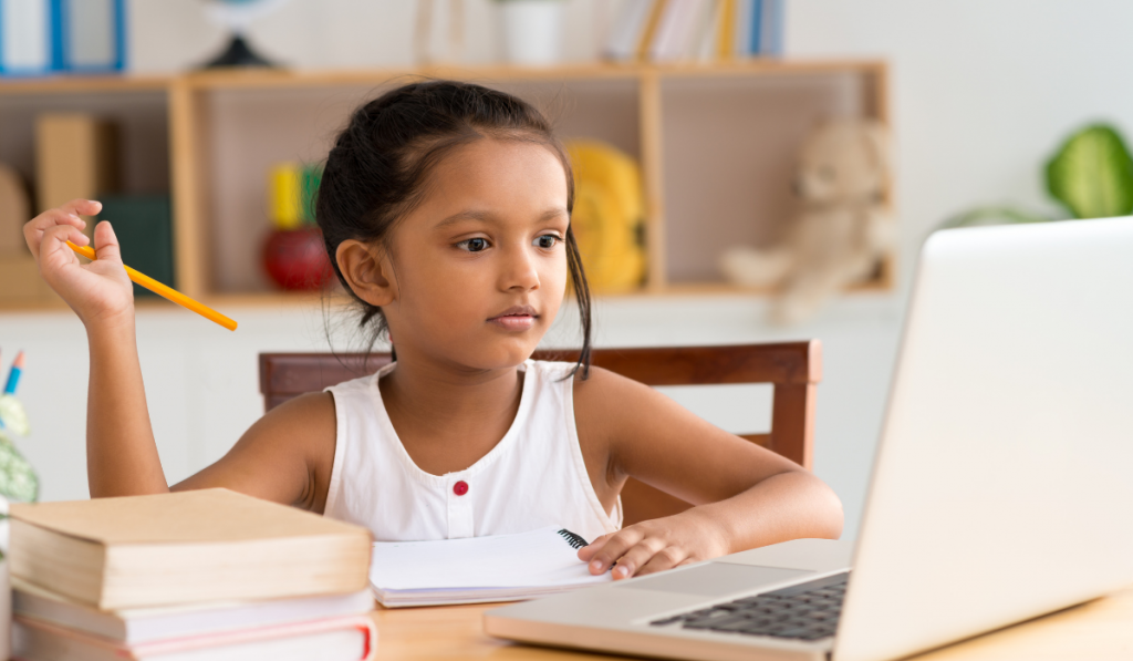 Child sitting in front of the laptop