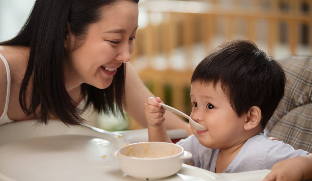 Parents influence childrens eating habits. Mother feeding her baby