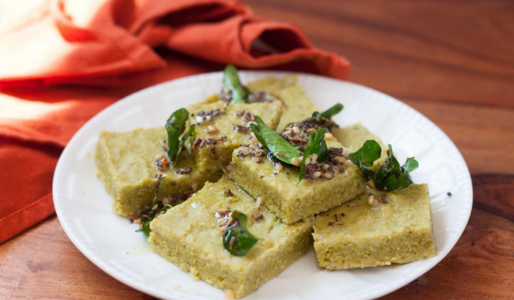 Palatable Foxtail Millet Spinach Dhoklas For All. Dhoklas kept on a white plate.