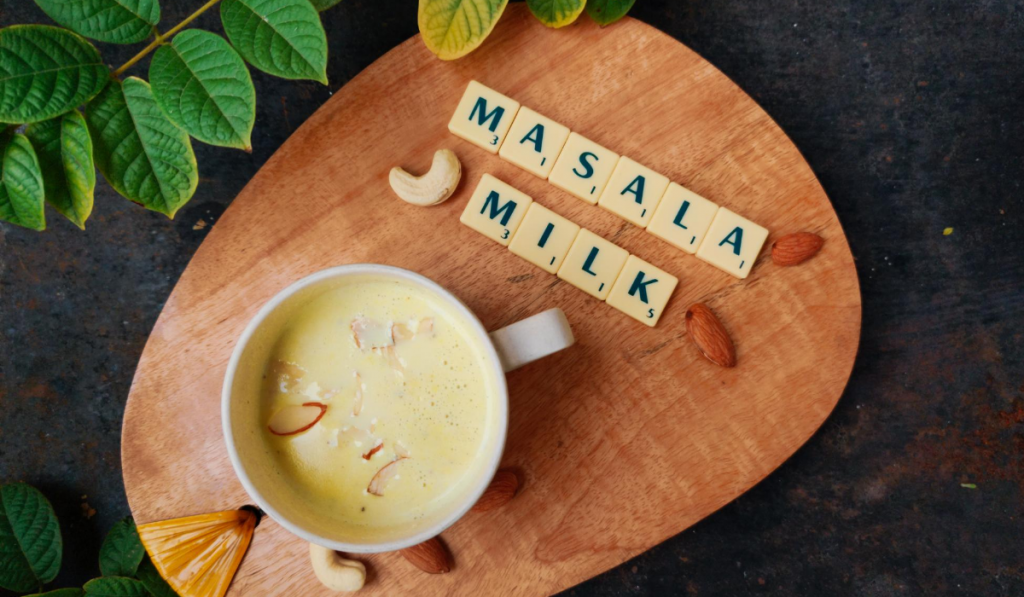 Healthy Drinks For Kids – Masala Milk. A cup of milk kept on a wooden tray
